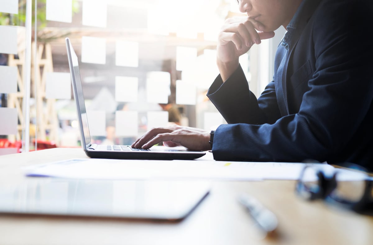 HR Analytics-man at laptop with pen