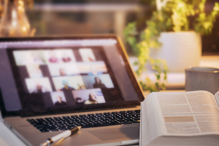 Laptop with book for Living Water Fellowship testimonial