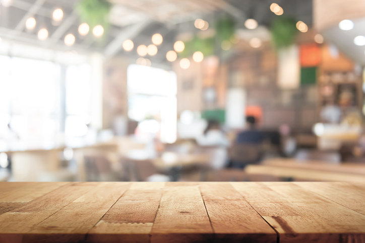 Wooden table in restaurant setting for La Cantina payroll testimonial