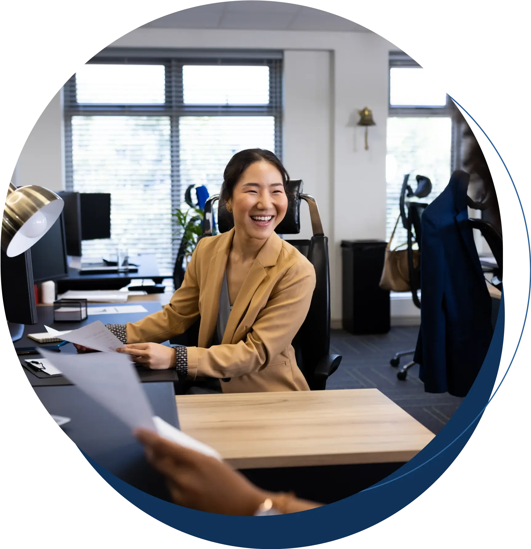 HR Professional smiling at desk talking to employee